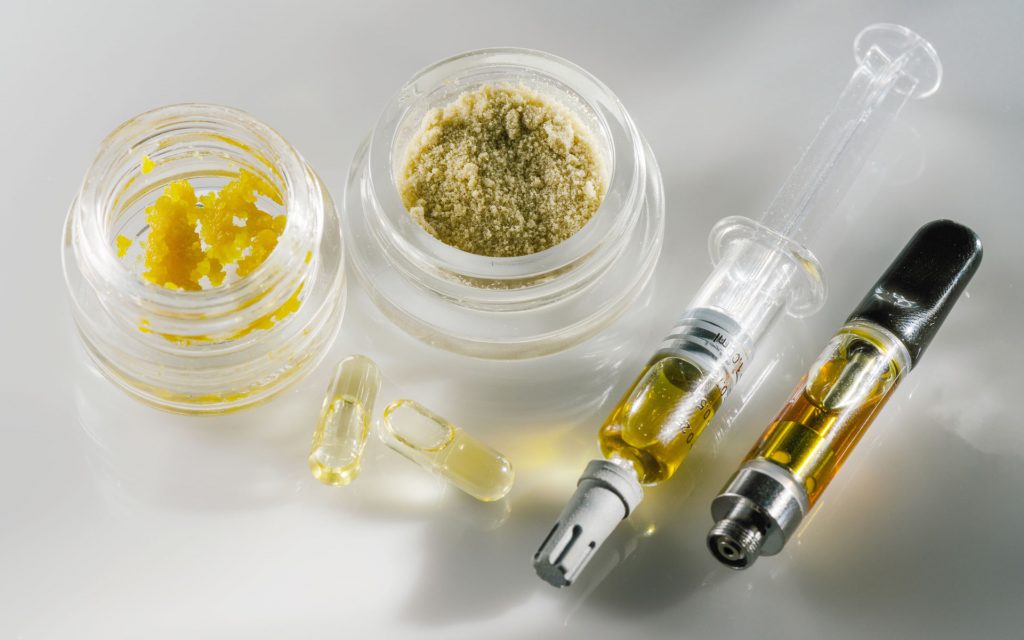 A variety of different cannabis concentrate types on a white background.